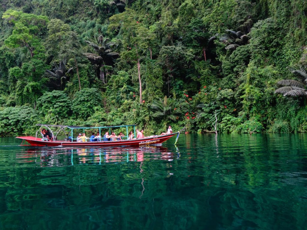 Un grupo de viaje de Fairaway Travel en un pequeño barco en Tailandia.